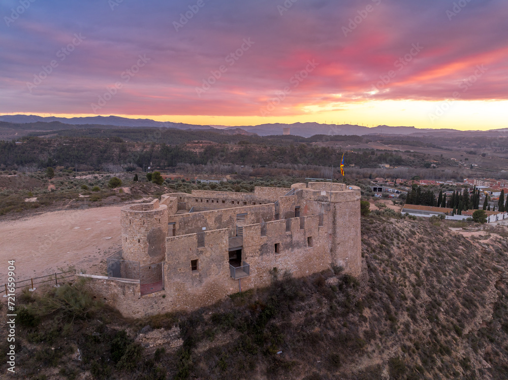 Aerial colorful sky sunset panoramic view of Flix new castle above the Ebro river in Spain with triangular shape circular gun platforms