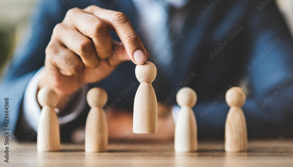 Wooden figure stands tall among diverse group, symbolizing leadership, unity, and influence in a collaborative environment Wooden figure stands tall among diverse group, symbolizing leadership, unity, and influence in a collaborative environment