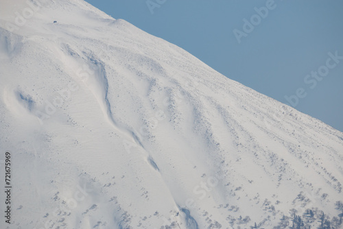 Snowcapped Yotei mountain peak and tiny rescue hut, Hokkaido, Japan