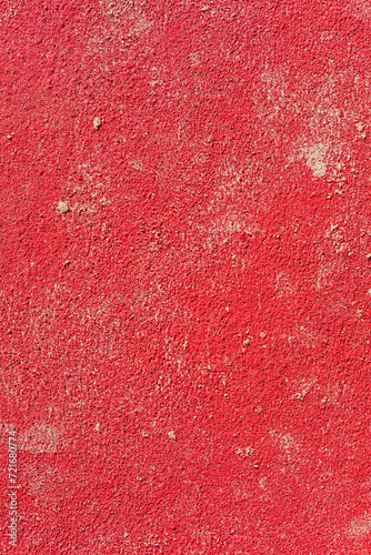 Intense red wall with scattered sand on a sunny day with hard light (ID: 721680774)