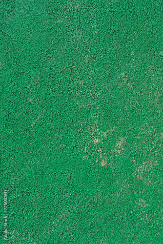 Intense green wall with scattered sand on a sunny day with hard light (ID: 721680937)