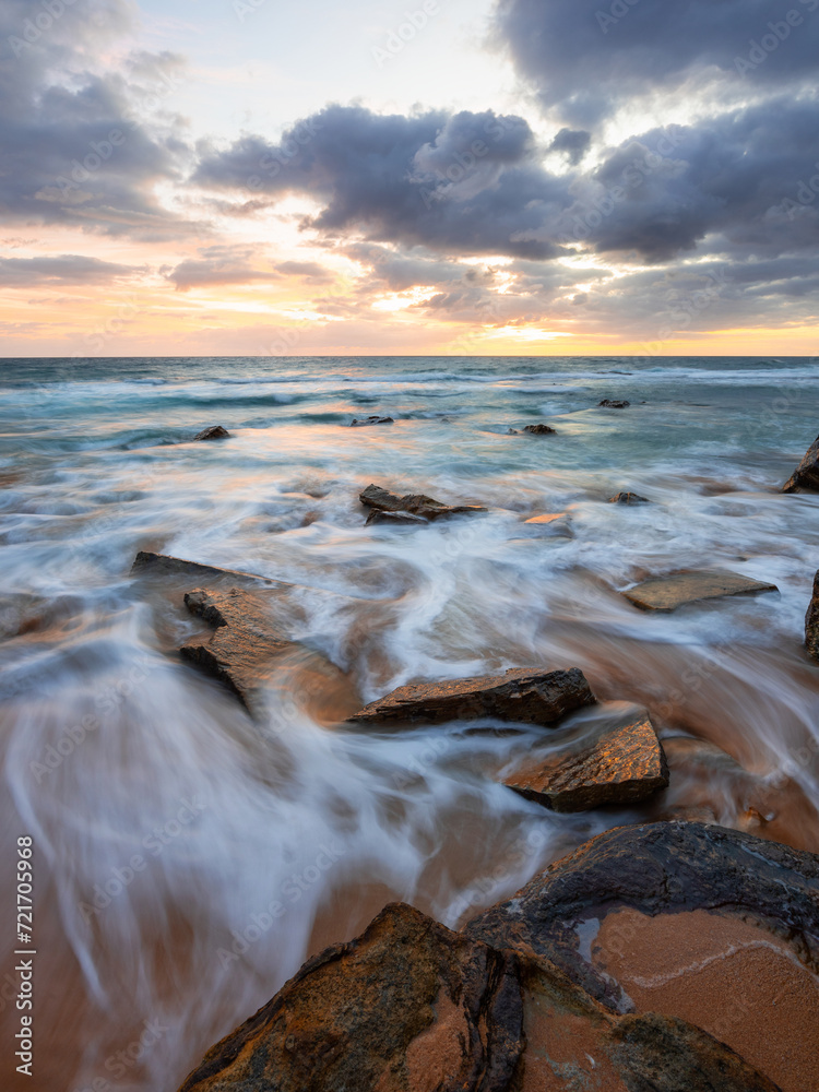 Rocky beach shore with flowing water. Rocky beach shore with flowing water.