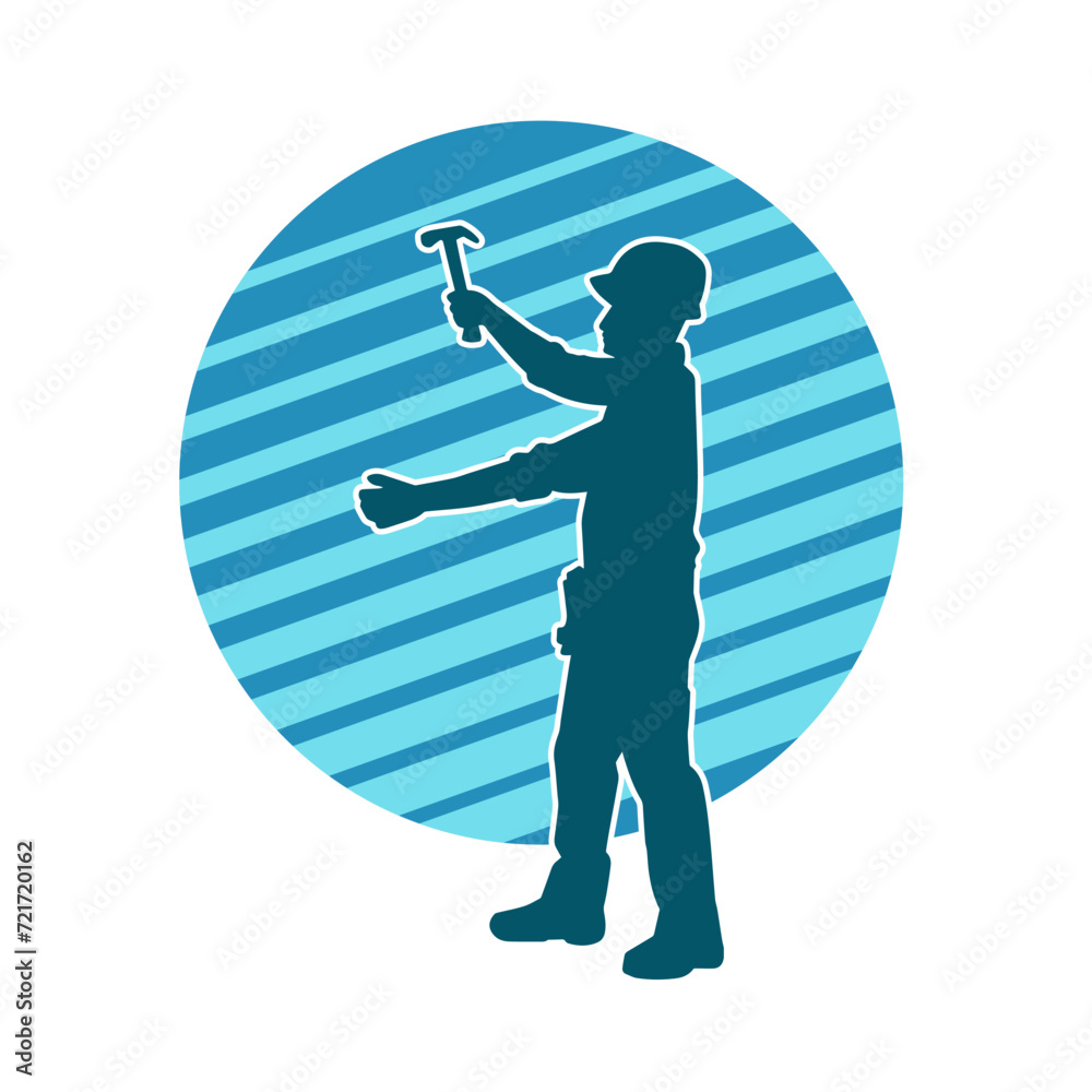 Obraz premium Silhouette of a worker carrying hammer tool. Silhouette of a worker in action pose using hammer tool.