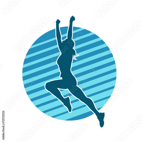 Silhouette of a happy slim woman jumping cheerfully.