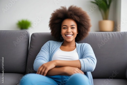 Happy afro american woman relaxing on the sofa at home - Smiling girl enjoying day off lying on the couch. Generative AI - 1
