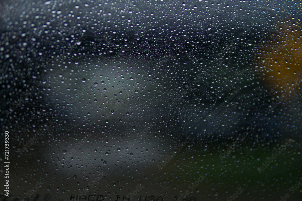 Obraz premium Water drop on​ glass of​ car​ on​ the​ Road​ in rainy season.