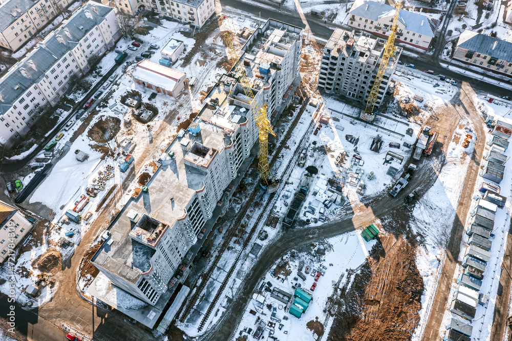 new high-rise residential building under construction. aerial view of construction site in winter.
