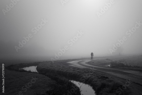 Man riding a bike in the fog