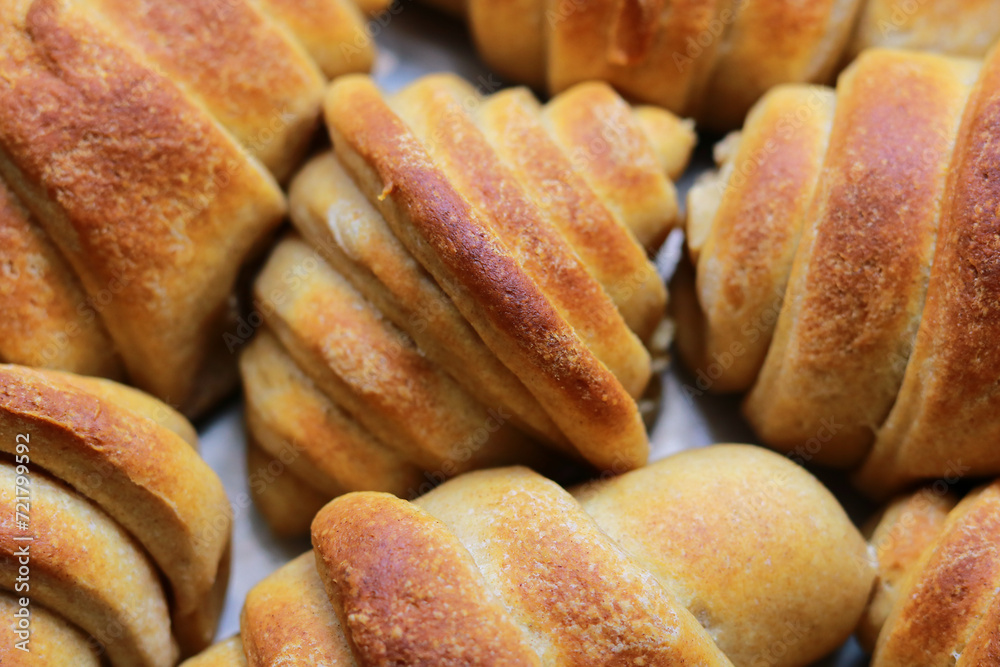 Freshly baked croissants in the form of buns.