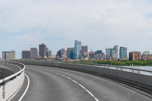 Empty urban asphalt road exterior with city buildings background. New modern highway concrete construction. Concept of way to success. Transportation logistic industry fast delivery. Boston. USA.