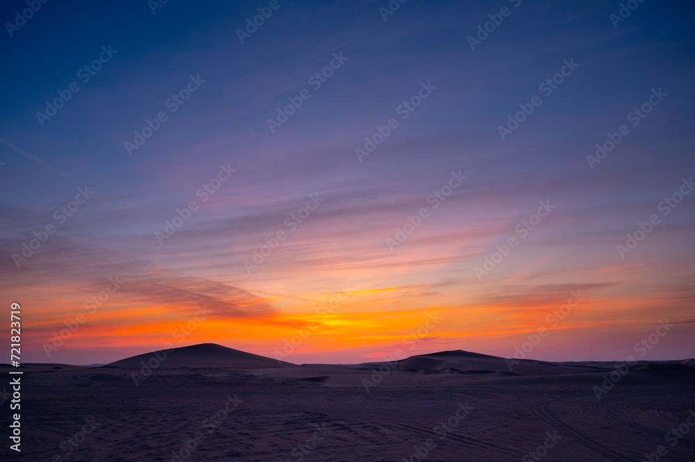 desert sand dune with beautiful clouds after sunset.