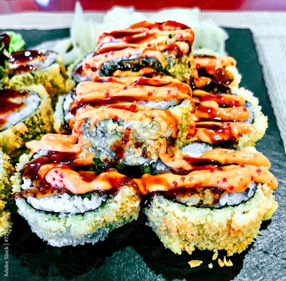 Sushi set on a black plate, close-up, top view