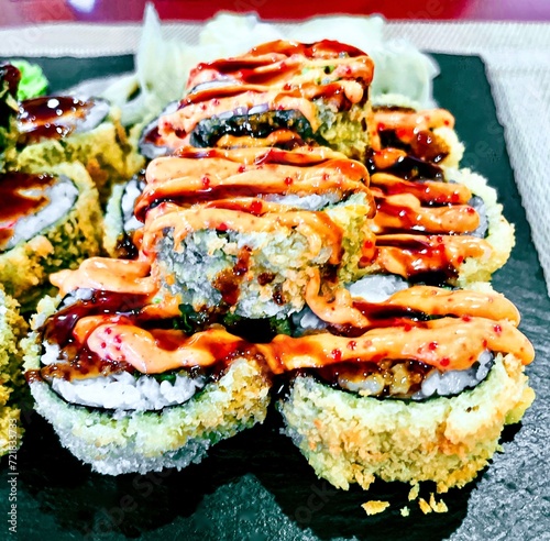 Obraz na płótnie Sushi set on a black plate, close-up, top view w salonie