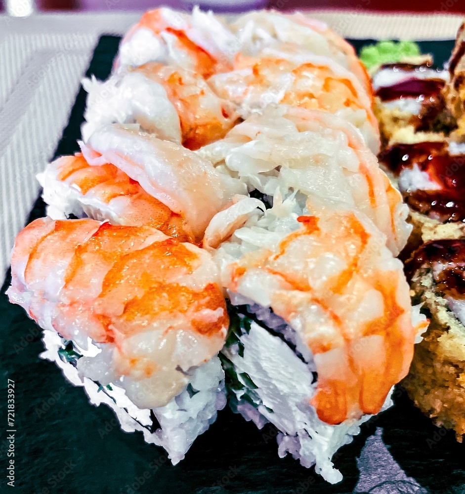 Sushi set on a black plate, close-up, top view