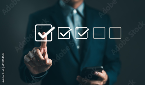 Checklist concept. Businessman tick correct sign mark in checkbox for quality document control checklist. Online test, Checkmark, Filling out digital form, Exam, Business technology. Project approval.