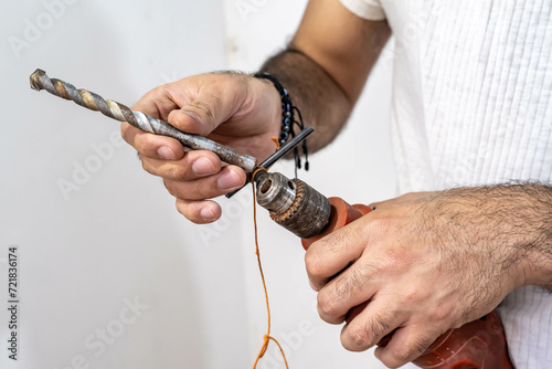 man working with drill © Daniel Ching