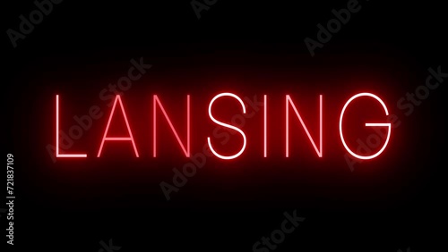 Flickering red retro style neon sign glowing against a black background for LANSING photo