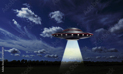 UFO. Alien spaceship emitting light beam over meadow