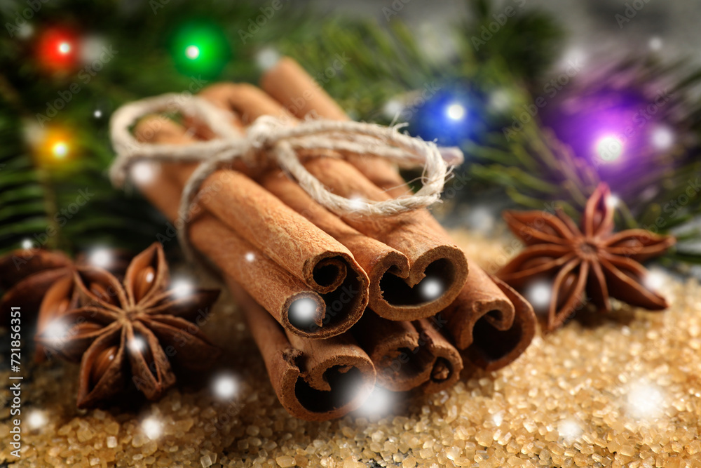 Different spices and fir tree branches on brown sugar, closeup. Cinnamon, anise, brown sugar Different spices and fir tree branches on brown sugar, closeup. Cinnamon, anise, brown sugar