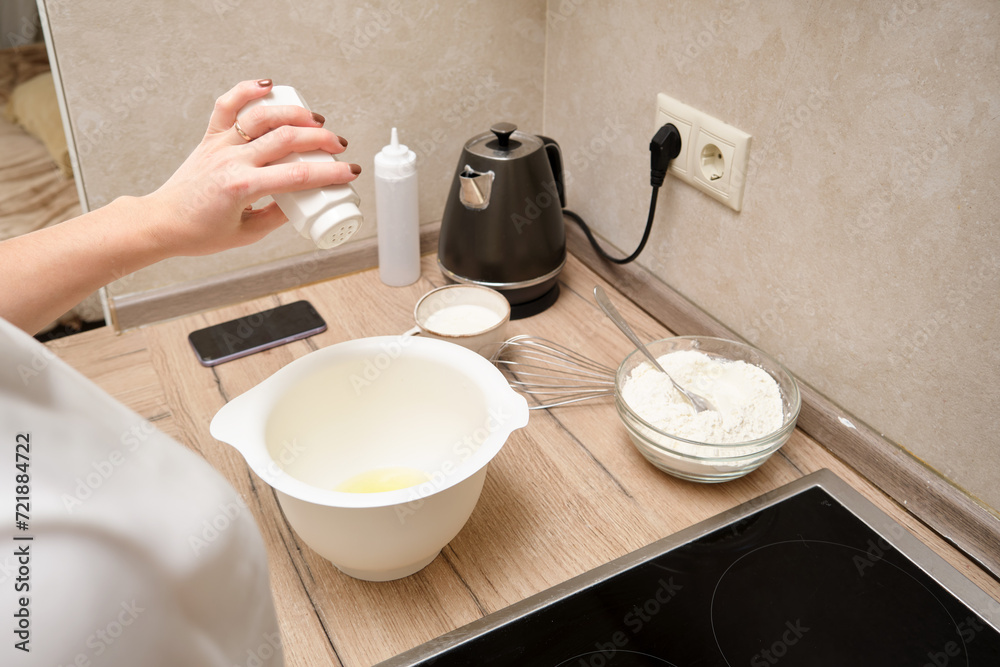 Woman preparing dough in the kitchen, close-up of hands. Woman preparing dough in the kitchen, close-up of hands.