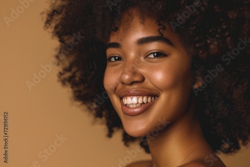 Beautiful portrait of African American woman with clean healthy skin and curly black hair. © darshika