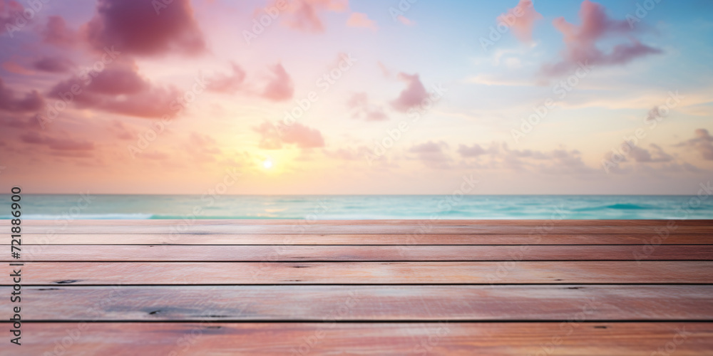 Wooden planks with with blurry beach and ocean with pastel pink clouds in sky in background