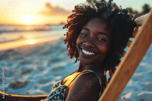 Happy African American woman sunbathing on tropical beach. Smiling girl enjoying vacation. photo