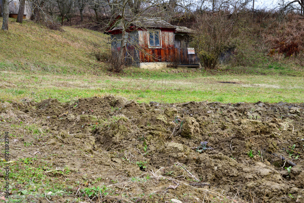 Farm wooden house in for farmer in the village with a field for planting