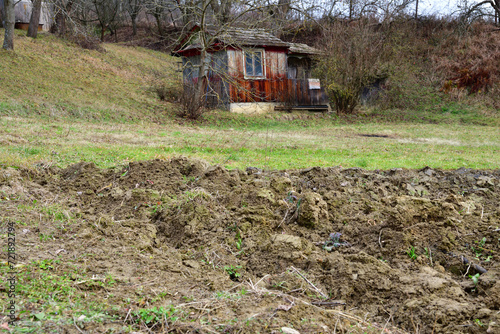 Obraz na płótnie Farm wooden house in for farmer in the village with a field for planting w salonie
