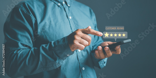 Customer Satisfaction concept, close up hand Man using smartphone with popup five star icon for feedback review satisfaction service, Customer service experience and business satisfaction survey.