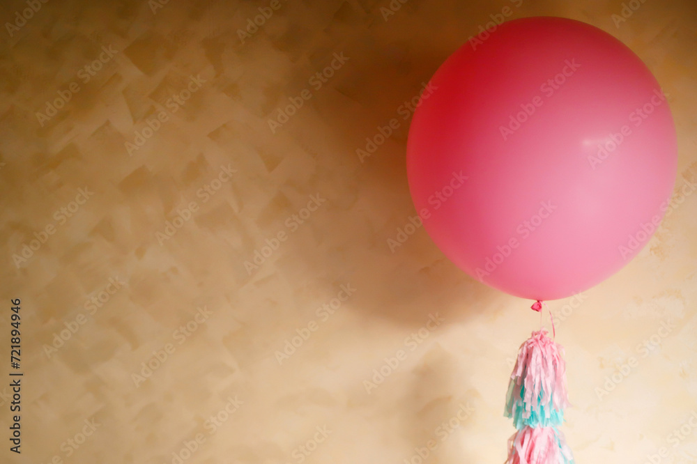 big pink balloon on a yellow background