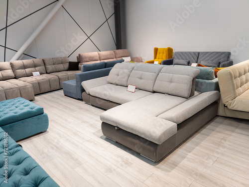 Furniture store with sofas and couches on display for sale, copy space. Shopping center with furniture department with sofas and couches.