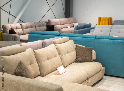 Furniture store with sofas and couches on display for sale, copy space. Showroom in the upholstered furniture store department with sofas.