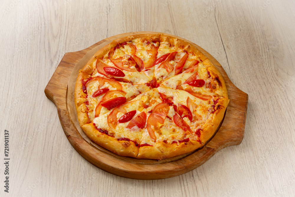 Pizza margherita. On a light wooden background.