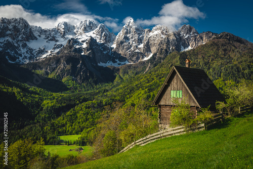Cozy small hut on the slope and snowy mountains  Slovenia