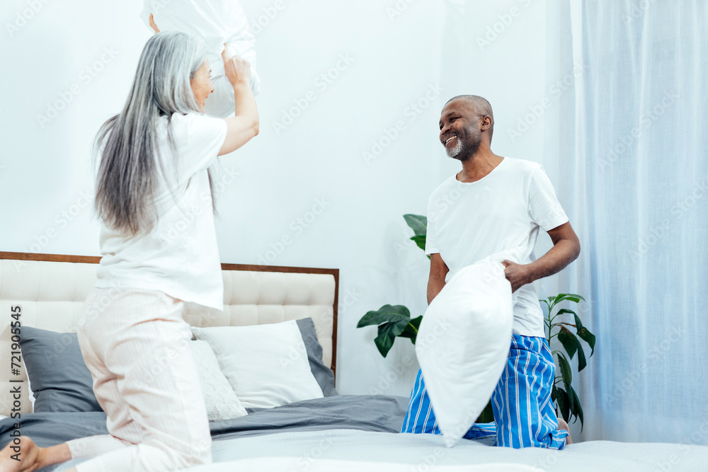 Obraz premium Cinematic image of an happy multiethnic senior couple.