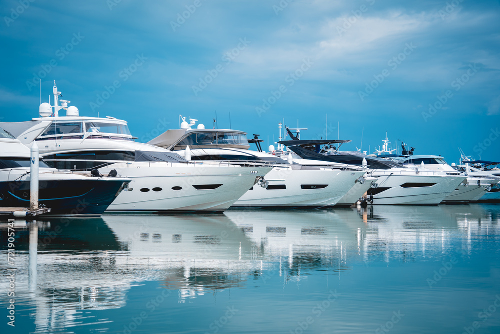 Many white modern yachts moored at the pier of marina. Many white modern yachts moored at the pier of marina.