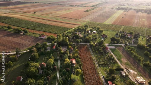 Drone footage of sunset in a village and plain patchwork of fields photo