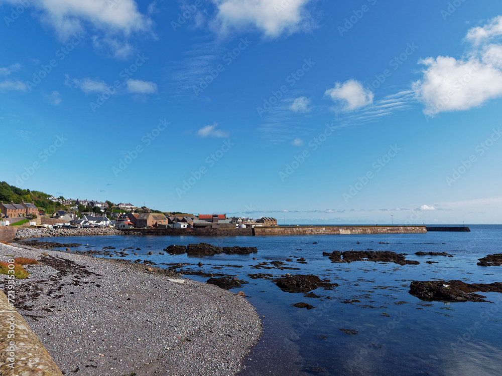 The old traditional Fishing Village of Gourdon at low tide on a warm sunny day in September on the Aberdeenshire Coast of Scotland.