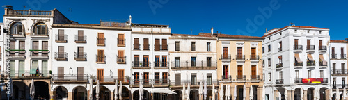 Facades of the old houses surrounding the Plaza Mayor in the city of Caceres, Spain. photo