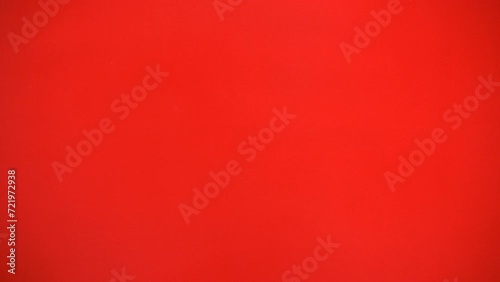 flat lay looping footage of hand holding a lot of ancient Chinese gold bar out from the top side for Chinese Lunar New Year celebration background, red theme with copy space photo