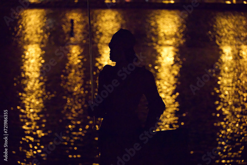 Night silhouette of statue on Charles Bridge in Prague