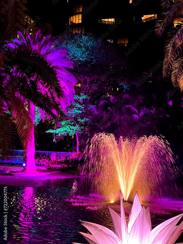 Neon Oasis: Twilight Fountain and Tropical Flora