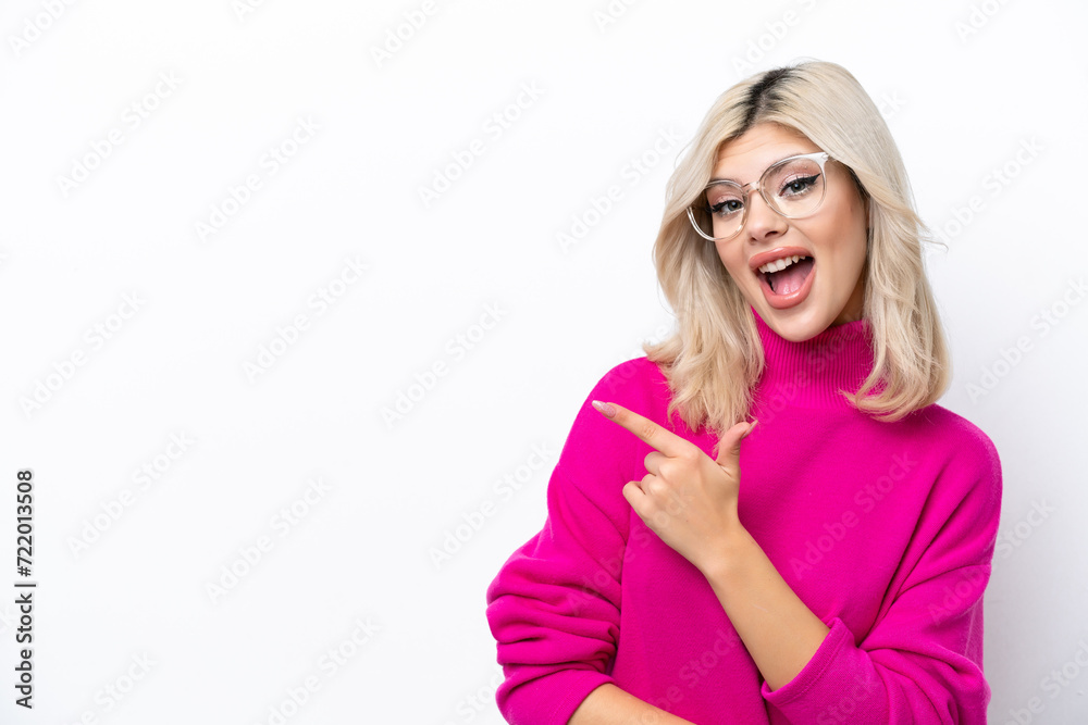 Young Russian woman isolated on white background surprised and pointing side Young Russian woman isolated on white background surprised and pointing side