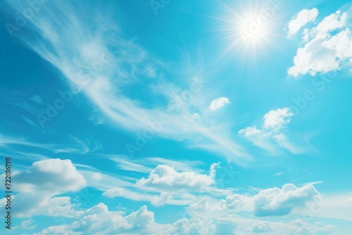 Blue sky with white clouds and bright sun photo