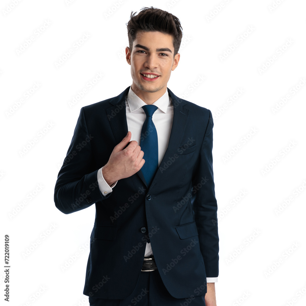 confident businessman smiling, looking forward and adjusting suit confident businessman smiling, looking forward and adjusting suit