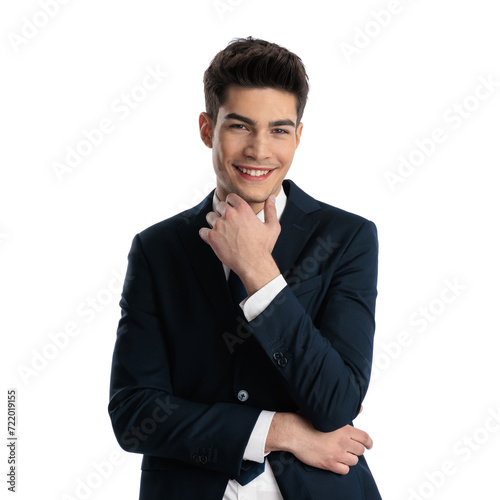 happy businessman in elegant suit folding arms, touching chin and laughing