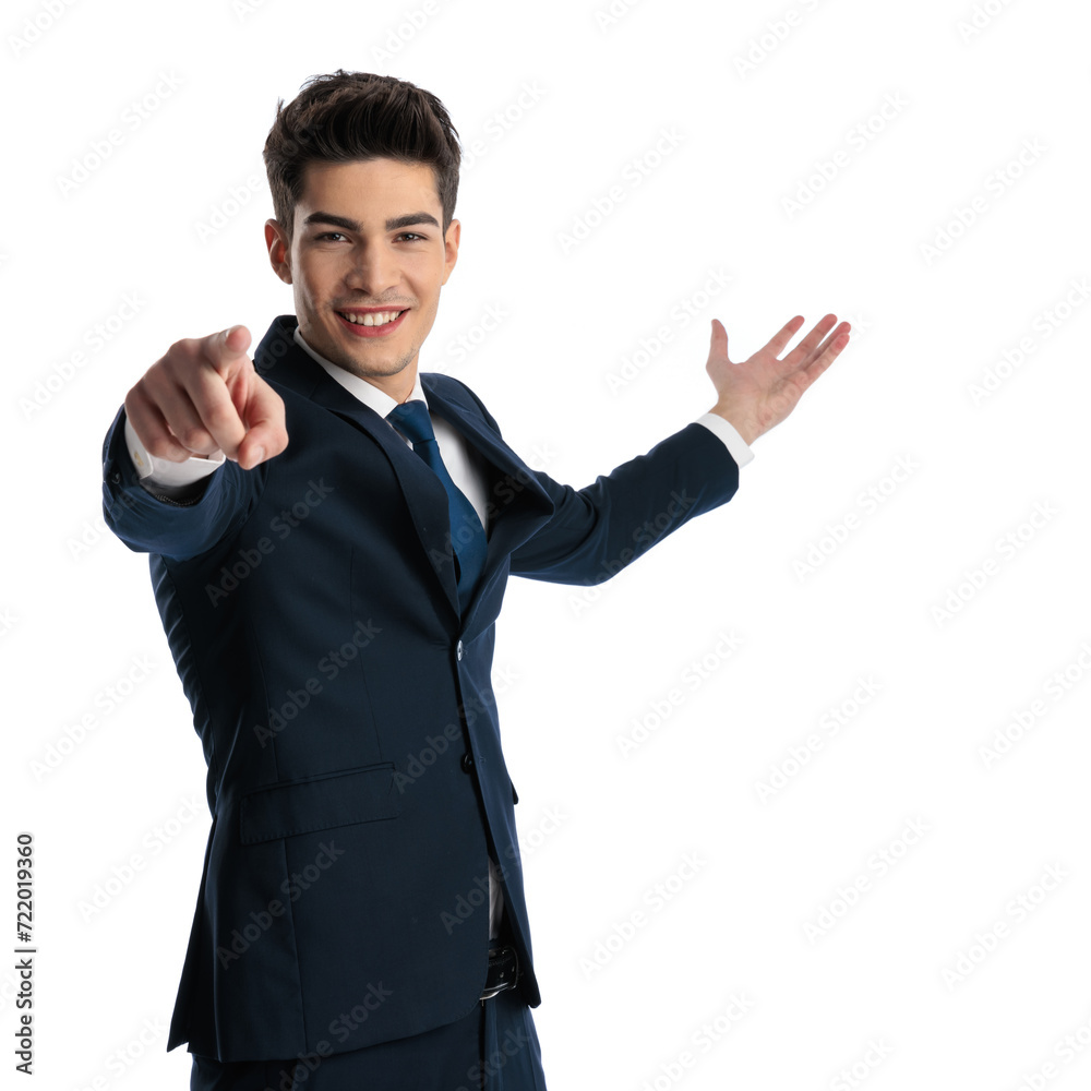 sexy elegant businessman in navy blue suit presenting to side and pointing finger sexy elegant businessman in navy blue suit presenting to side and pointing finger