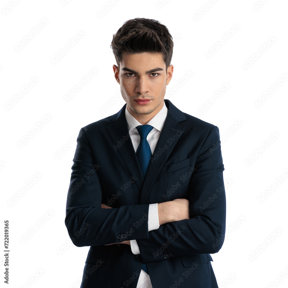 serious young businessman in navy blue suit crossing arms and looking forward serious young businessman in navy blue suit crossing arms and looking forward