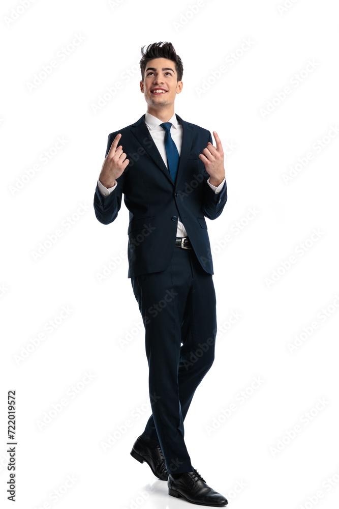 happy young man pointing finger up to the sky and walking happy young man pointing finger up to the sky and walking